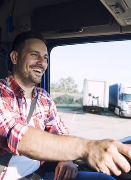 Smiling trucker in semi - owner-operator insurance