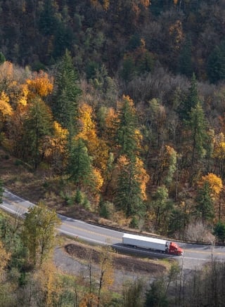 Truck driving on forest highway - risk financing