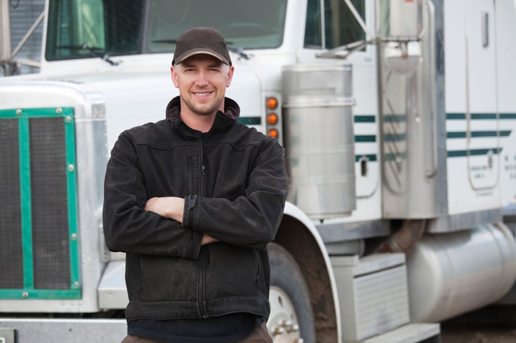 Owner-Operator standing in front of semi truck